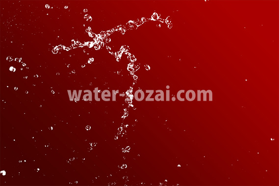 赤い背景の水が跳ねる写真・フォト