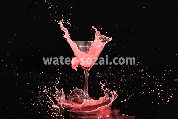 カクテルグラスと赤い液体が弾ける写真・フォト素材