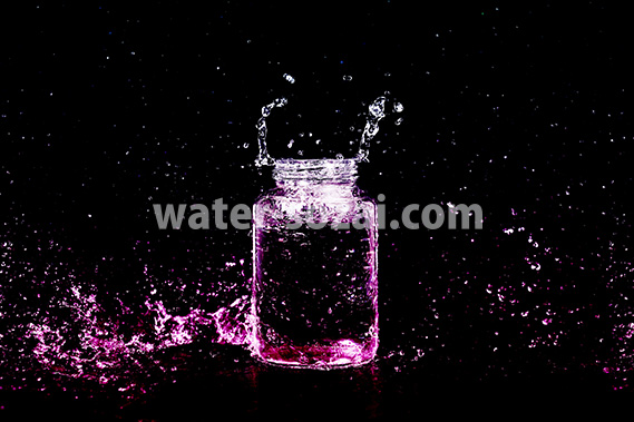 ピンク色に着色されたビンと水しぶきの写真・フォト素材