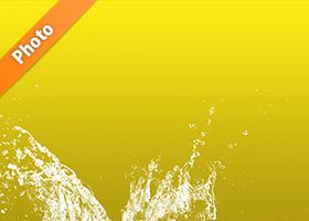 黄色背景の水飛沫が上がる写真・フォト